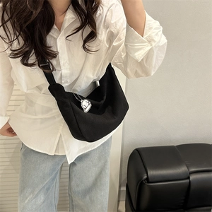 Minimalist black crescent corduroy crossbody bag with a cute white sheep charm