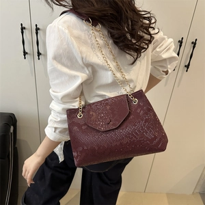 Women's burgundy faux leather shoulder bag with snakeskin texture and gold chain strap