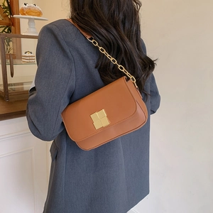 Brown leather shoulder bag with gold square buckle shown from back perspective