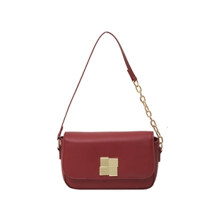 Elegant wine red chain underarm bag with gold metal clasp on white background
