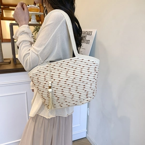 Contrast woven straw tote bag with brown stripes and decorative tassel for summer