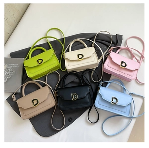 Detail showing various colors of small crossbody bags with metallic gold D buckle