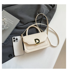 Detail of cream mini square bag with golden D-buckle and phone for size comparison