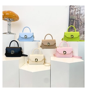 Detailed display of assorted small square crossbody bags featuring a gold D-buckle closure