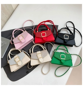 Flat lay of six colorful mini square handbags featuring glossy PU leather and gold D-rings