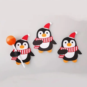 Detail of penguin Halloween candy cards with red hats for lollipop decorations