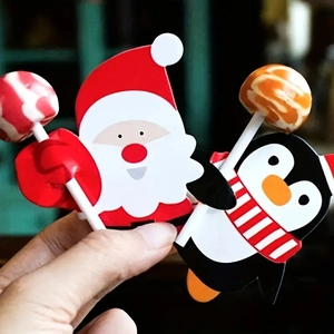 Detail of DIY Christmas lollipop paper cards featuring Santa Claus and penguin designs