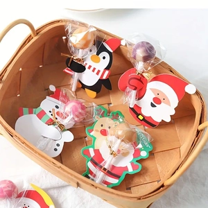 Close-up of Christmas lollipop decoration cards with Santa and Penguin in a basket
