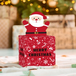 Detailed view of red Christmas candy box featuring Santa Claus and snowflake patterns