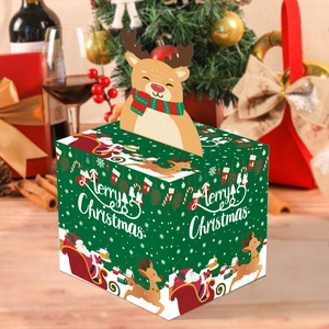 Detailed view of square green Christmas gift box featuring 3D reindeer and snowy village art