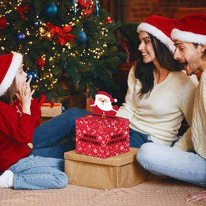 Detailed view of red Christmas candy box with 3D Santa Claus popup and festive snow prints