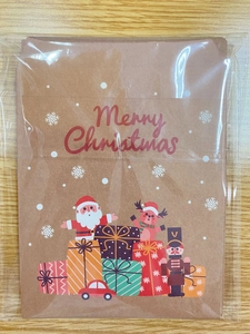 Detail of kraft paper Christmas gift envelope featuring Santa Claus and nutcracker motifs