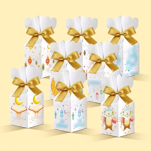 Detail of Ramadan gift boxes set with moon and lantern patterns and gold ribbons