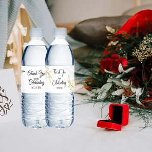 Detail showing adhesive Thank You labels for water bottles with gold botanical design