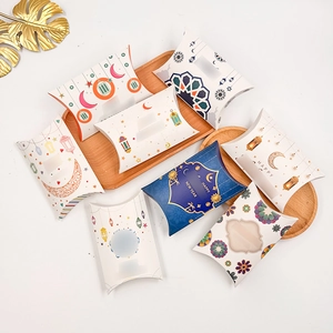 Macro detail of crescent moon and star patterns on festive pillow gift boxes