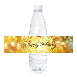 Detail of glittery Happy Birthday water bottle labels with elegant gold bokeh pattern