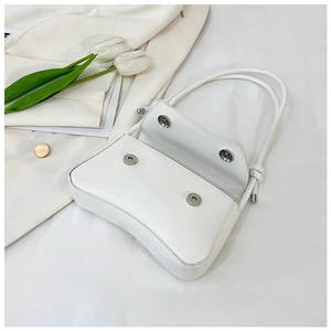Close-up of the white leather shoulder bag interior with magnetic snap closures
