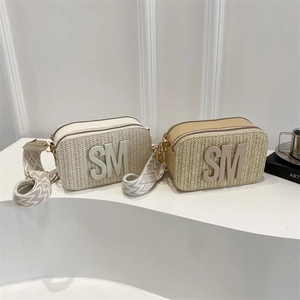 Straw woven crossbody camera bag with leather trim and geometric jacquard strap