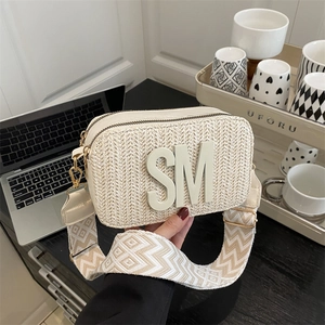 Chic beige straw crossbody bag with SM logo and geometric wide shoulder strap