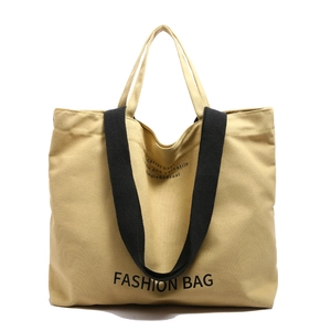 Vintage canvas tote bag with black wide strap and letter print on yellow canvas