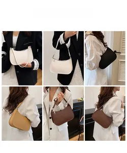 Detail showing various colors of the minimalist crescent shoulder bag in lychee texture