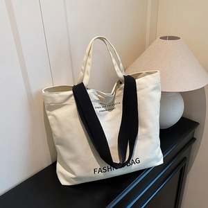 Minimalist canvas tote bag with black handles and fashion letter print for women