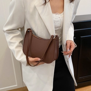Brown lychee leather baguette bag with minimalist half-moon shape for women