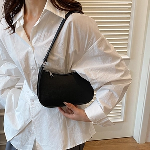 Modern black pebble leather hobo shoulder bag styled with an oversized white shirt