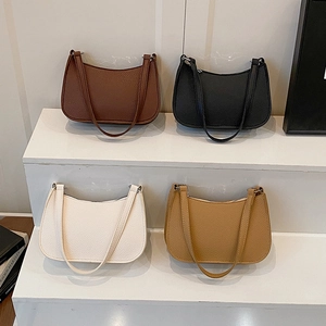 Chic solid color hobo shoulder bags in leather texture displayed on white steps