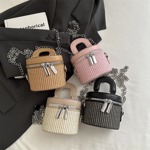 Mini woven bucket bags in contrast leather and straw with top handles and chain straps