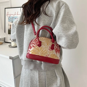 Red and cream shell bag with floral embroidery, double handles and crossbody strap