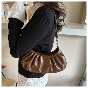 Detail of soft leather dark brown pleated cloud hobo bag with a sleek shoulder strap