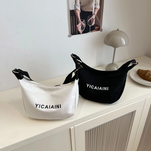 Minimalist nylon half-moon crossbody bags in black and white with wide shoulder straps