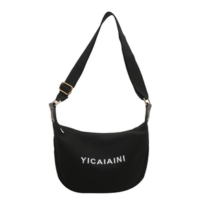 Minimalist black canvas crescent tote bag with white letter print and adjustable strap