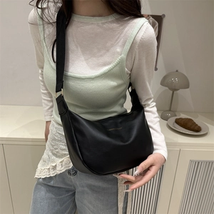 Chic black crescent crossbody bag in matte PU leather with wide adjustable fabric strap