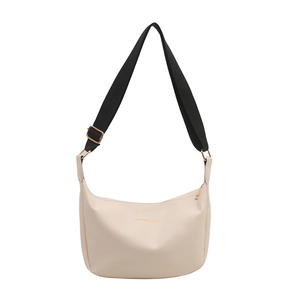 Chic beige half-moon tote with wide black shoulder strap and gold hardware accents
