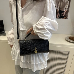 Elegant black crocodile embossed baguette bag with gold lock and braided shoulder strap