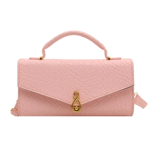 Pink faux leather woven handbag with crocodile texture and gold infinity metal clasp