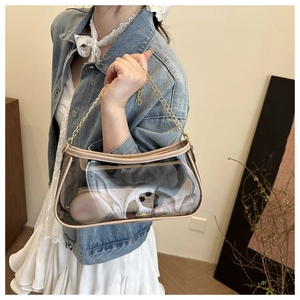 Close-up of transparent PVC crossbody bag with beige faux leather trim and gold chain