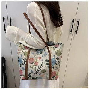 Detail of vintage floral jacquard tote bag with dark brown shoulder straps
