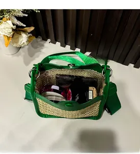 Detail view showing interior capacity of the green woven straw crossbody square bag