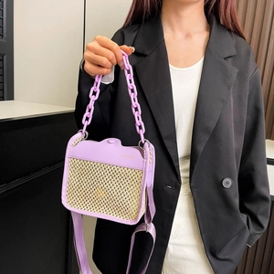 Detail of light purple straw woven bag with leather flap and metal chain strap