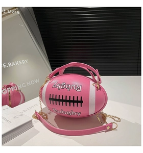 Macro detail of pink rugby-shaped mini bag with PU leather texture and gold chain strap