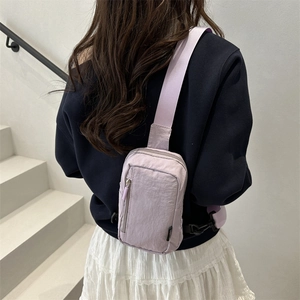 Fashionable light purple nylon chest bag for men and women shown on a model outdoors