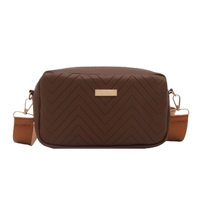 Deep brown quilted camera bag with V-shaped stitching and wide adjustable strap