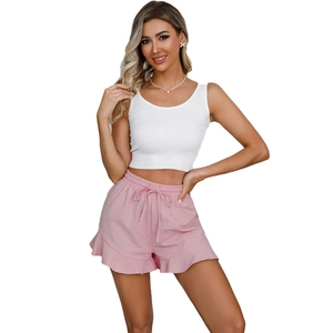 Detail of pink cotton shorts with ruffle hem and drawstring waist for summer wear