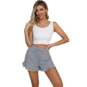 Detail of grey cotton linen shorts with drawstring waist and ruffle trim decoration