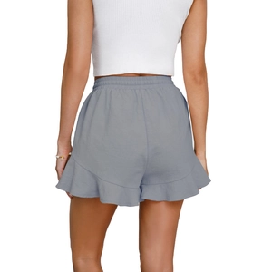 Detail of grey cotton linen shorts with ruffled hem and elastic drawstring waistband