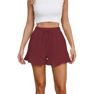Detail of burgundy cotton shorts showing elastic drawstring waist and ruffled hem
