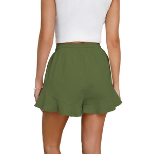 Detail view of olive green cotton linen shorts featuring elastic waist and ruffle hem